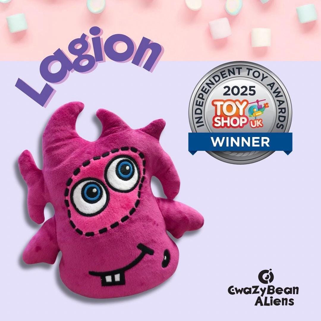 CwaZyBean Aliens Lagion Pink alien plush toy from CwaZyLeigh CreaTions with blue eyes on a light pink background, featuring the 'Lagion' brand and Toy Shop UK award.